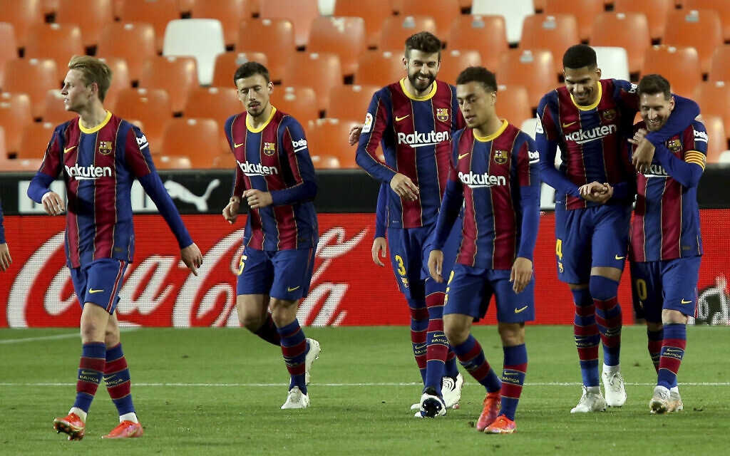 Barcelona's Lionel Messi celebrates with team mates scoring his side's 3rd goal during the Spanish La Liga soccer match between Valencia and Barcelona at the Mestalla stadium in Valencia, Spain, Sunday, May 2, 2021. (AP Photo/Alberto Saiz)