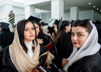 Women graduates celebrate after more than 100 Afghan students from the American University of Afghanistan (AUAF) receive their diplomas at a graduation ceremony on campus on 21 May 2019