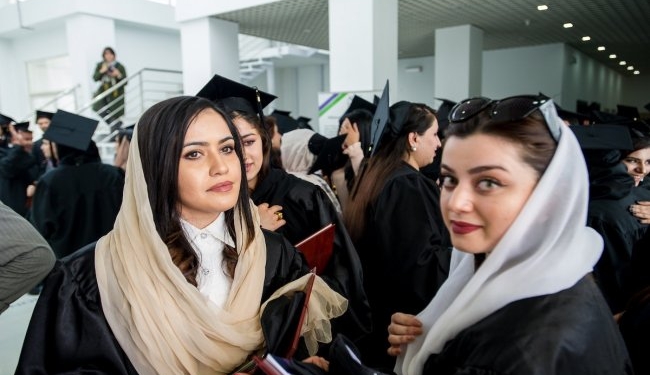 Women graduates celebrate after more than 100 Afghan students from the American University of Afghanistan (AUAF) receive their diplomas at a graduation ceremony on campus on 21 May 2019