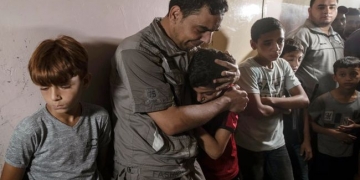 Relatives of Palestinian Omar al-Neil, 12, who was shot by an Israeli sniper during a demonstration on the eastern border between Gaza and Israel, react during his funeral in the family home in Gaza City, Saturday, Aug. 28, 2021