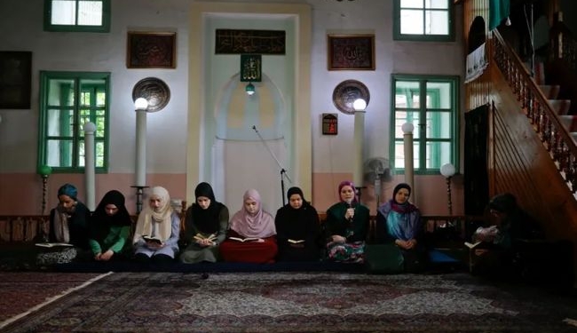 Young women recite the Quran during Ramadan at a mosque in Sarajevo, Bosnia and Herzegovina