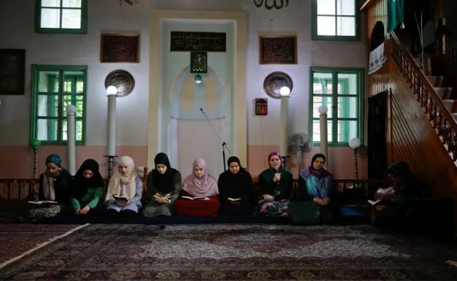 Young women recite the Quran during Ramadan at a mosque in Sarajevo, Bosnia and Herzegovina